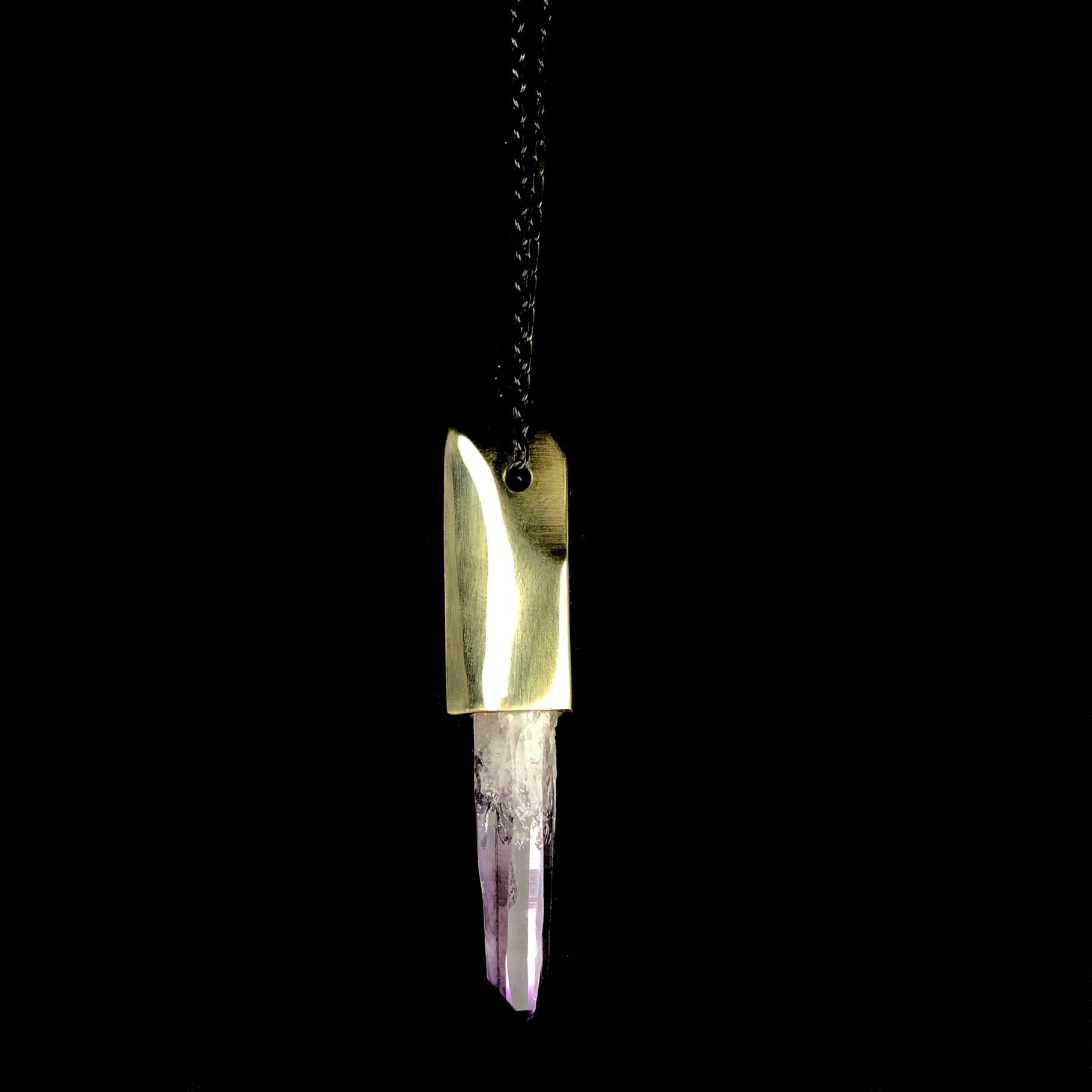 Close up view of Amethyst Crystal in Faceted Brass Cap 