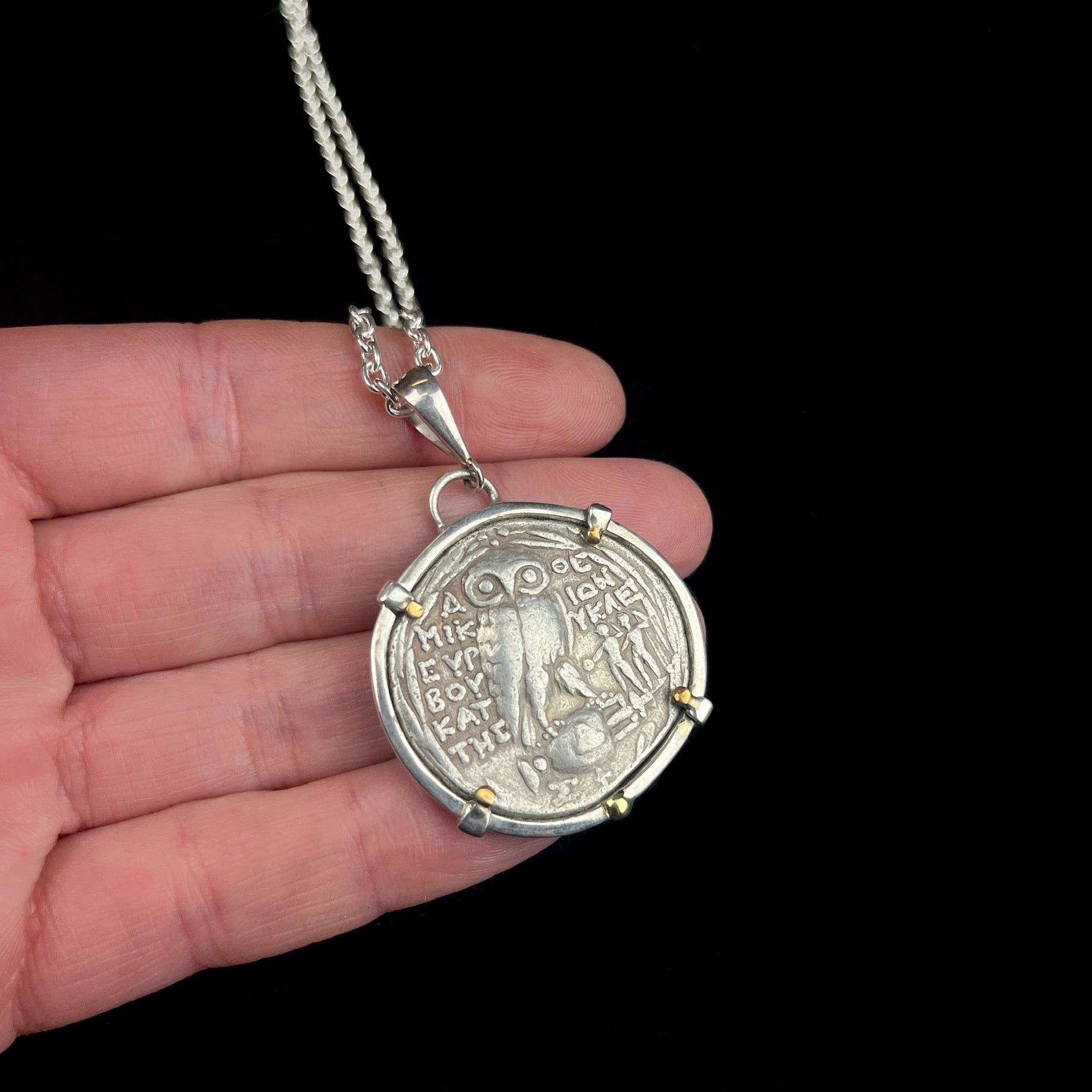 Athena Tetradrachm Coin Pendant shown in hand with owl side facing up