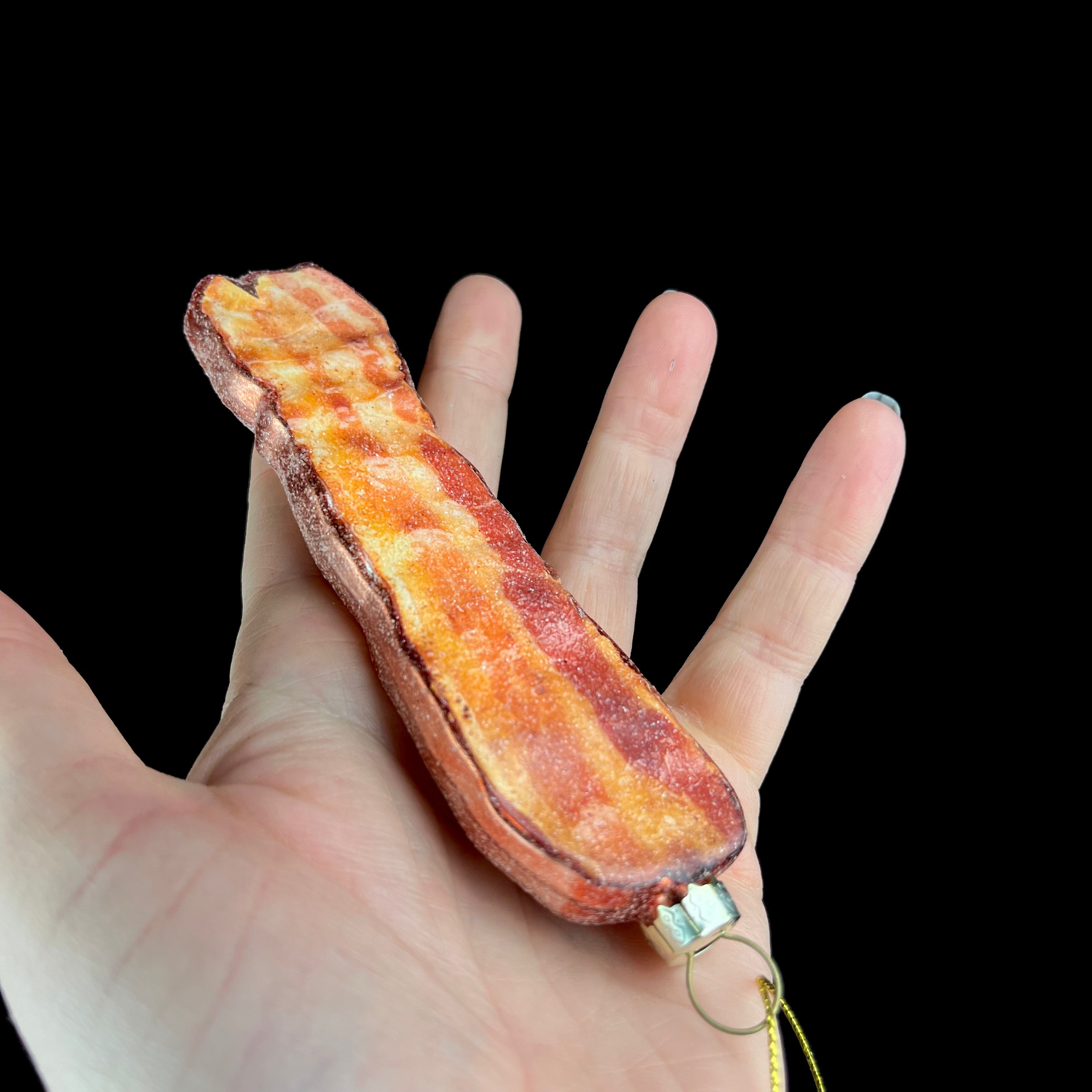 Bacon Ornament shown in hand