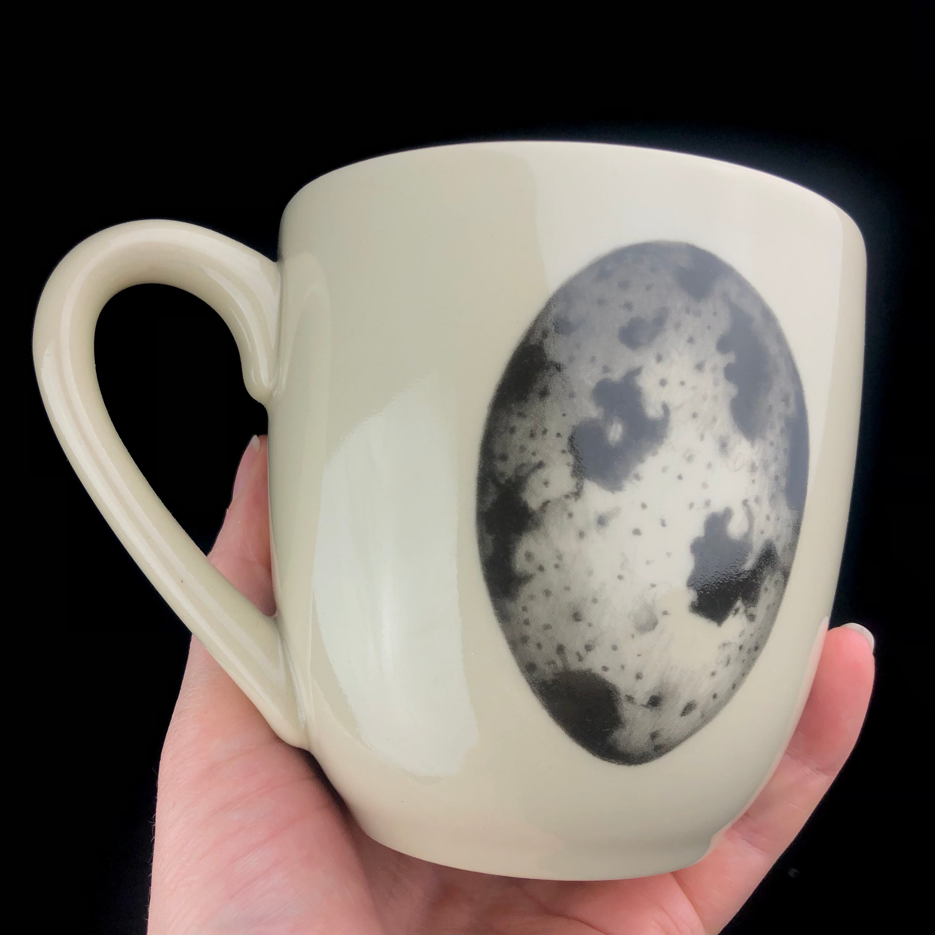 Zindel Mug with Egg graphic shown held in hand