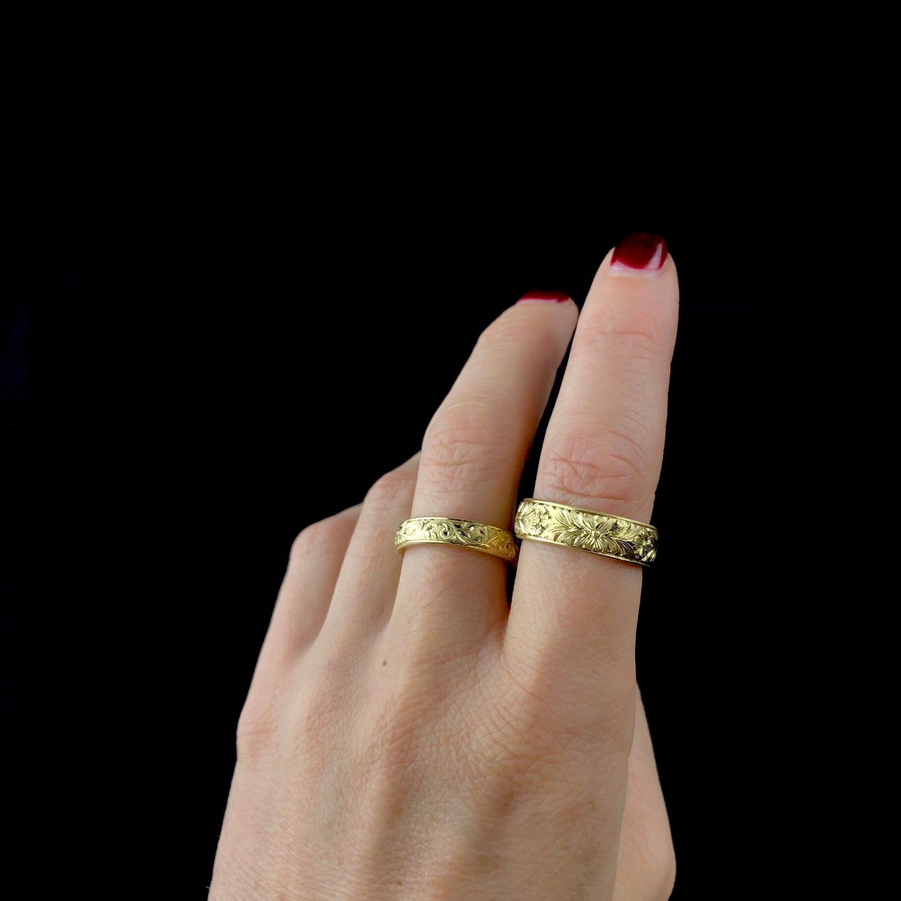 Engraved Wide Gold Band shown on pointer finger