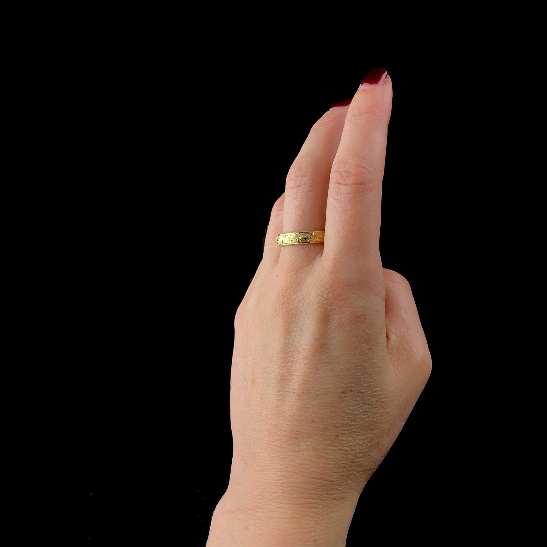 Engraved Gold Band shown worn on middle finger