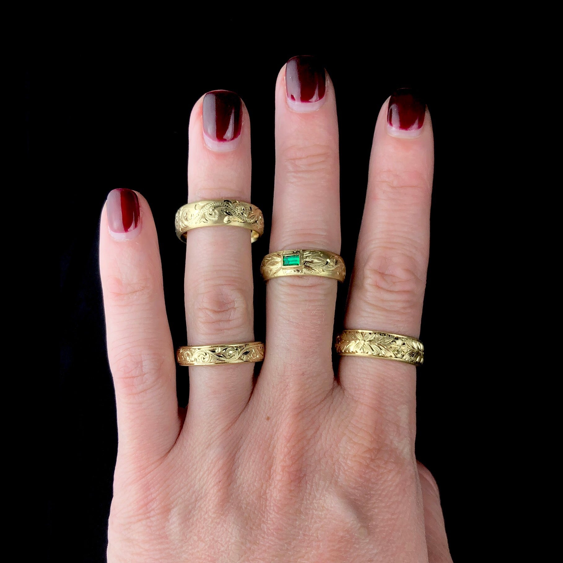 Back side of Ruby Ring shown worn on far right of hand with other bands