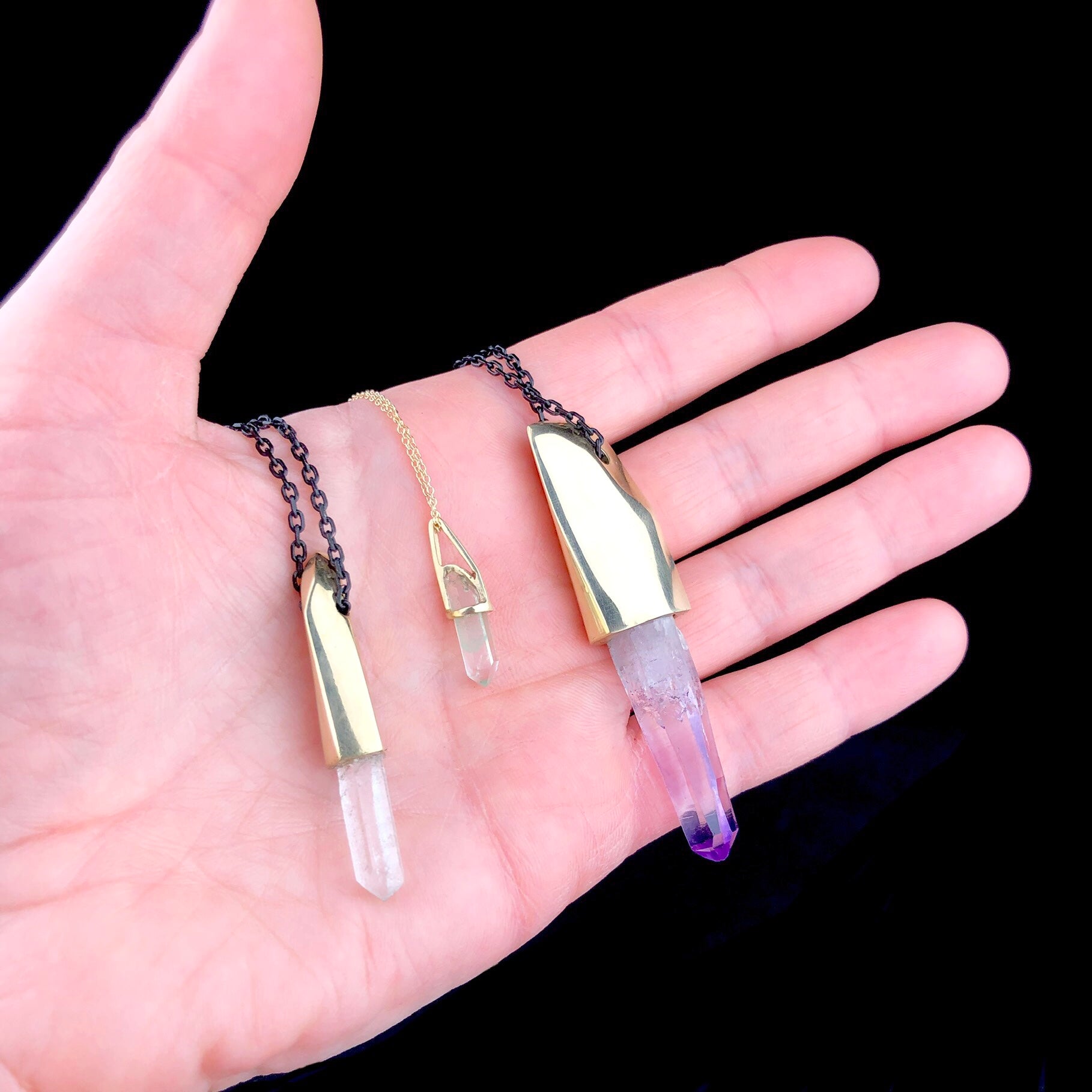 Crystal Necklaces shown in hand