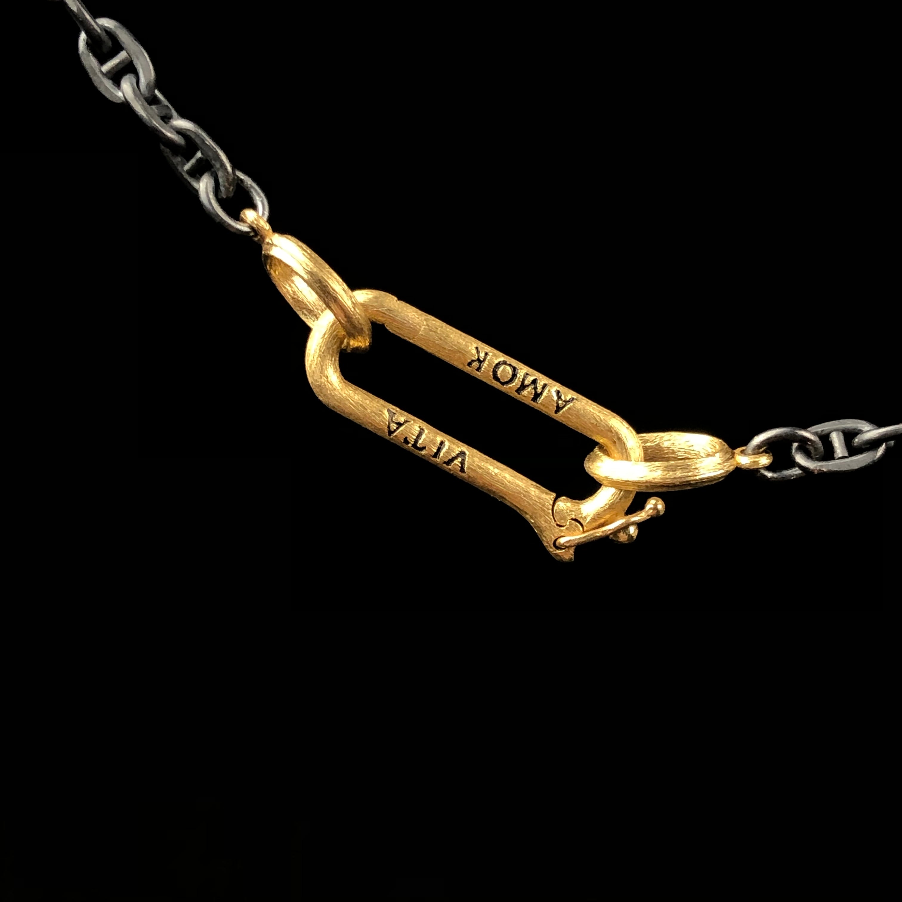 The back side of White Diamond Paperclip Charm Holder or Chain Closure with the words AMORE and VITA