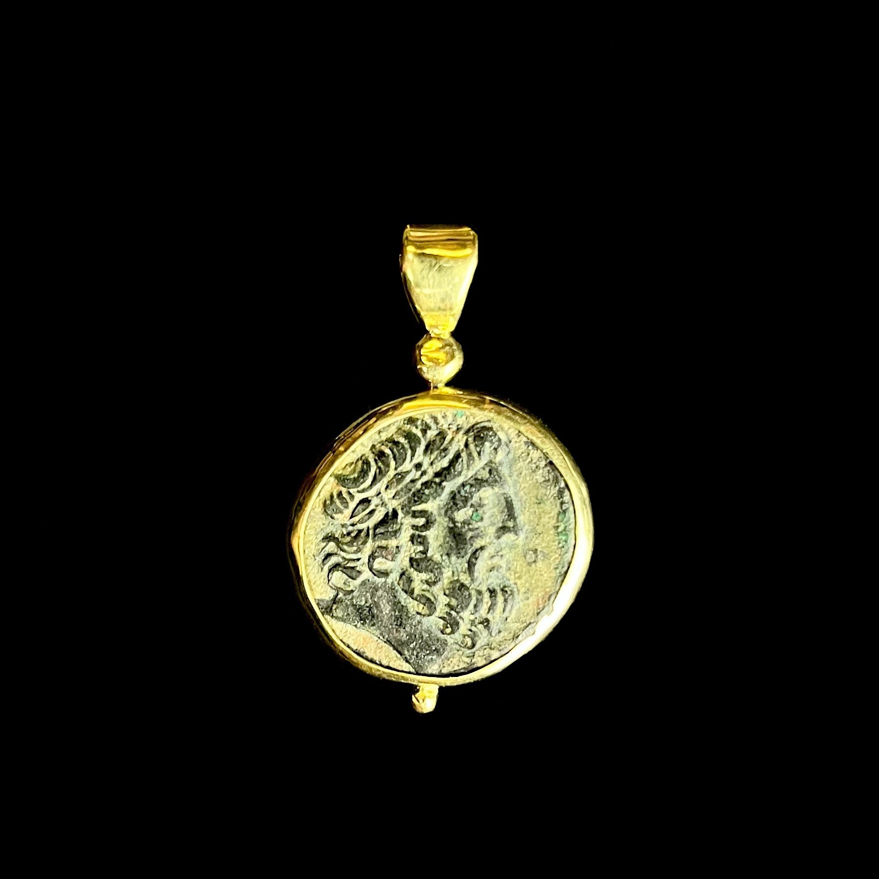 coin pendant with bearded face of looking right