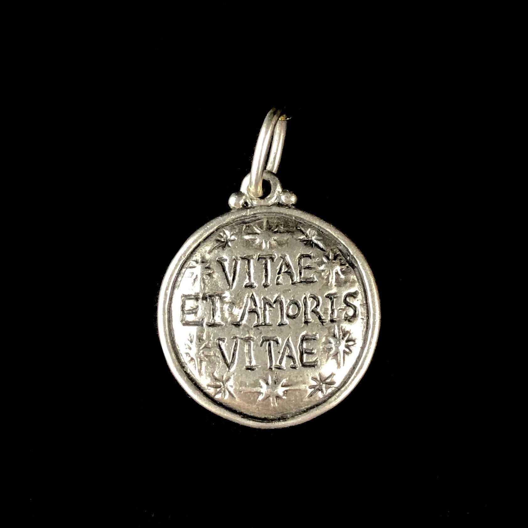 Back side of Free of Life Charm with Italian words