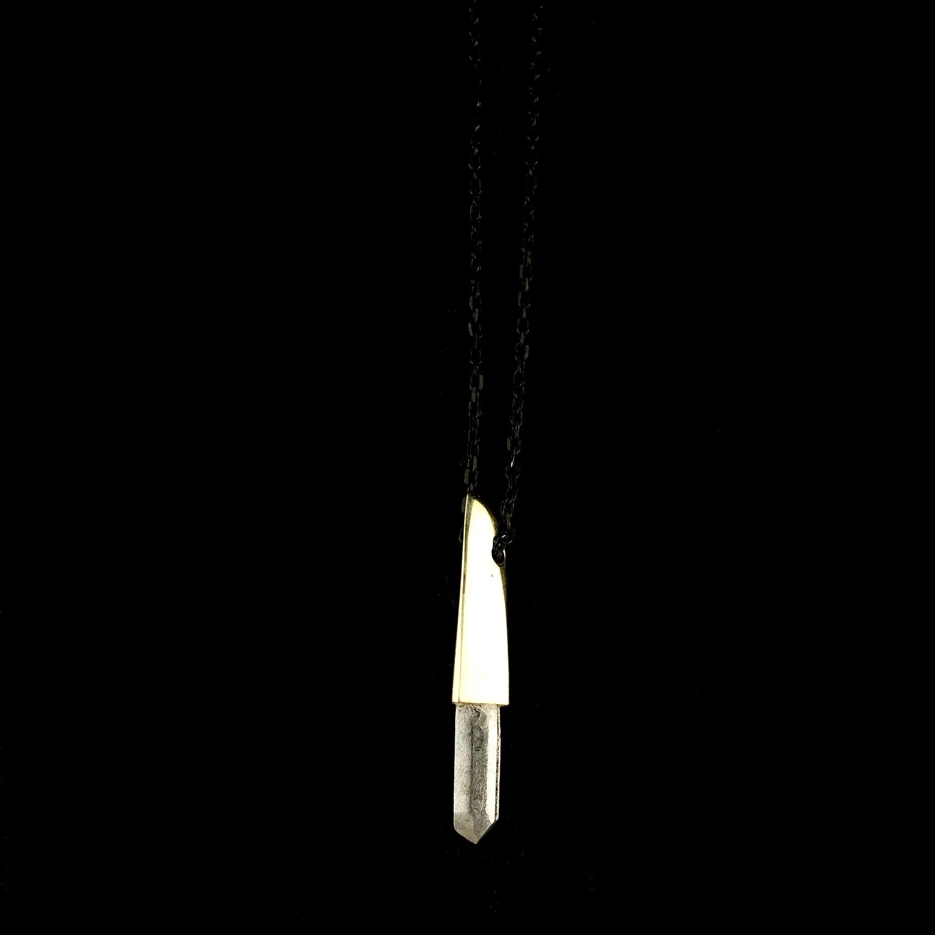 Clear Crystal protruding from brass faceted cap Pendant on Black chain