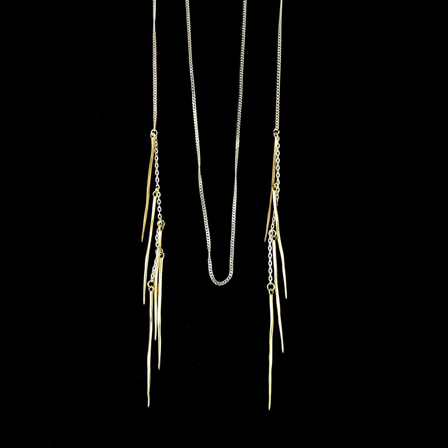 Brass Spike details at each end of a delicate silver chain