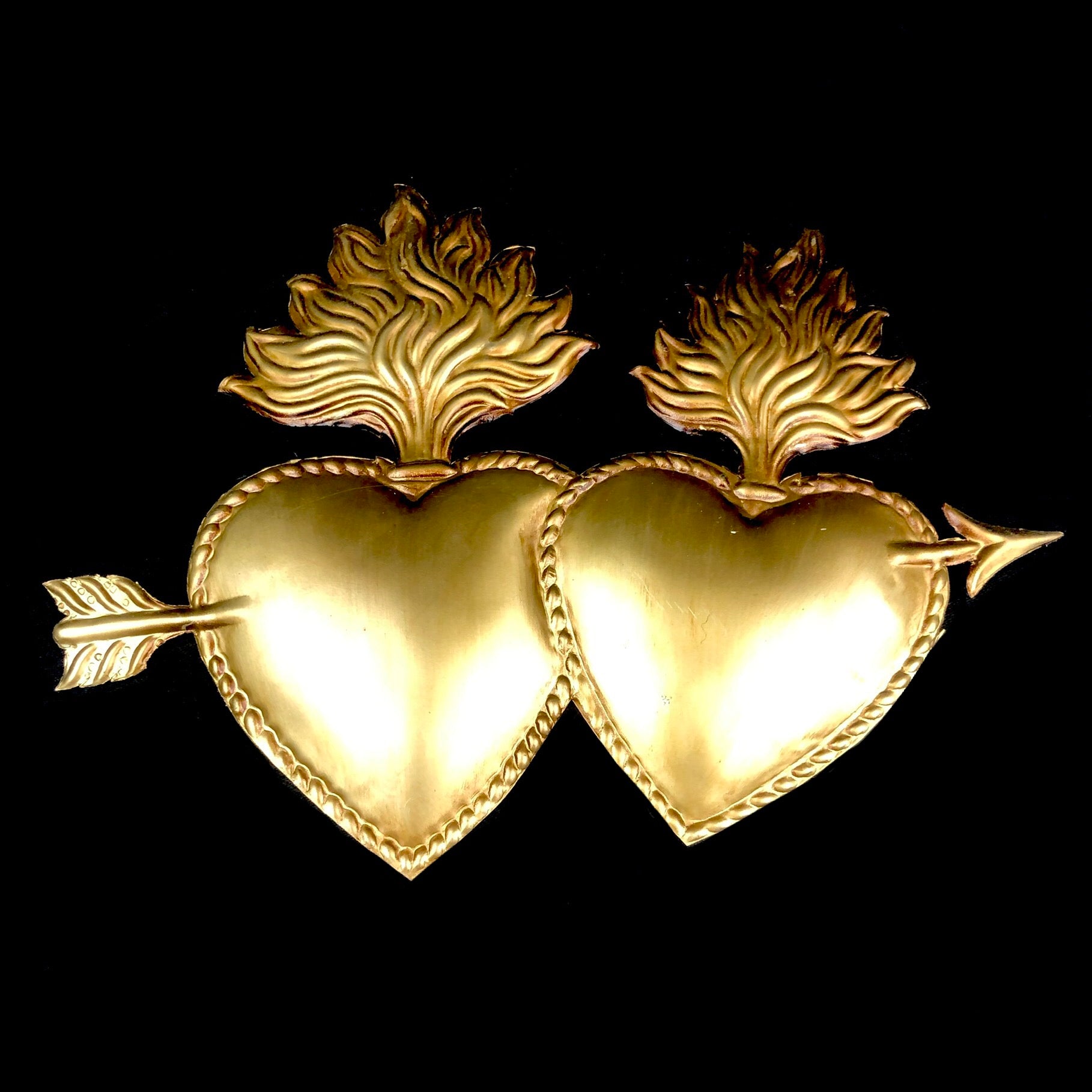 Two sacret hearts with arrow and flames